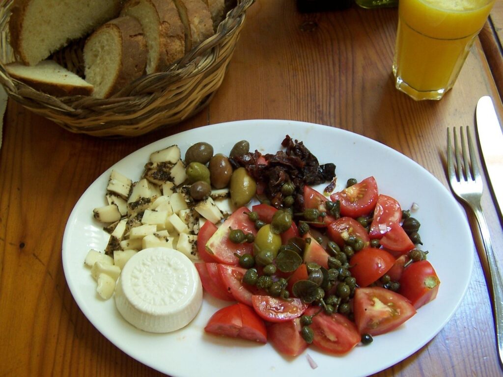 Värske salat päikesekuivatatud tomatiga, varske tomatiga, juustutükikestega, oliividega ja kapparitega.jpg